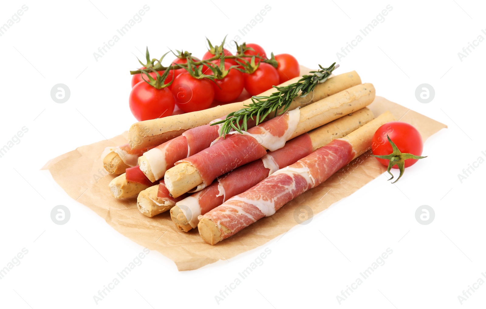 Photo of Delicious grissini sticks with prosciutto, tomatoes and rosemary on white background
