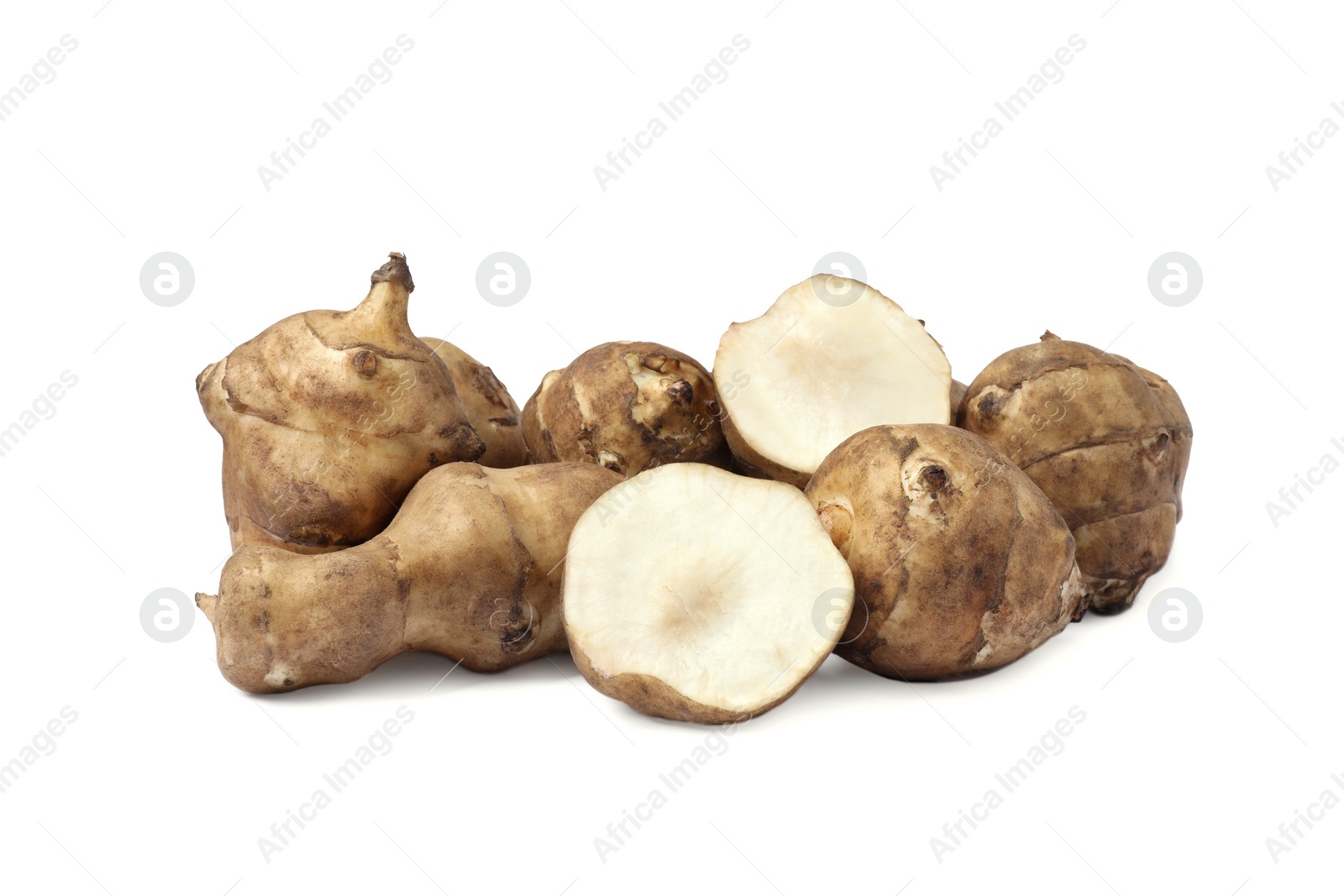 Photo of Whole and cut Jerusalem artichokes isolated on white