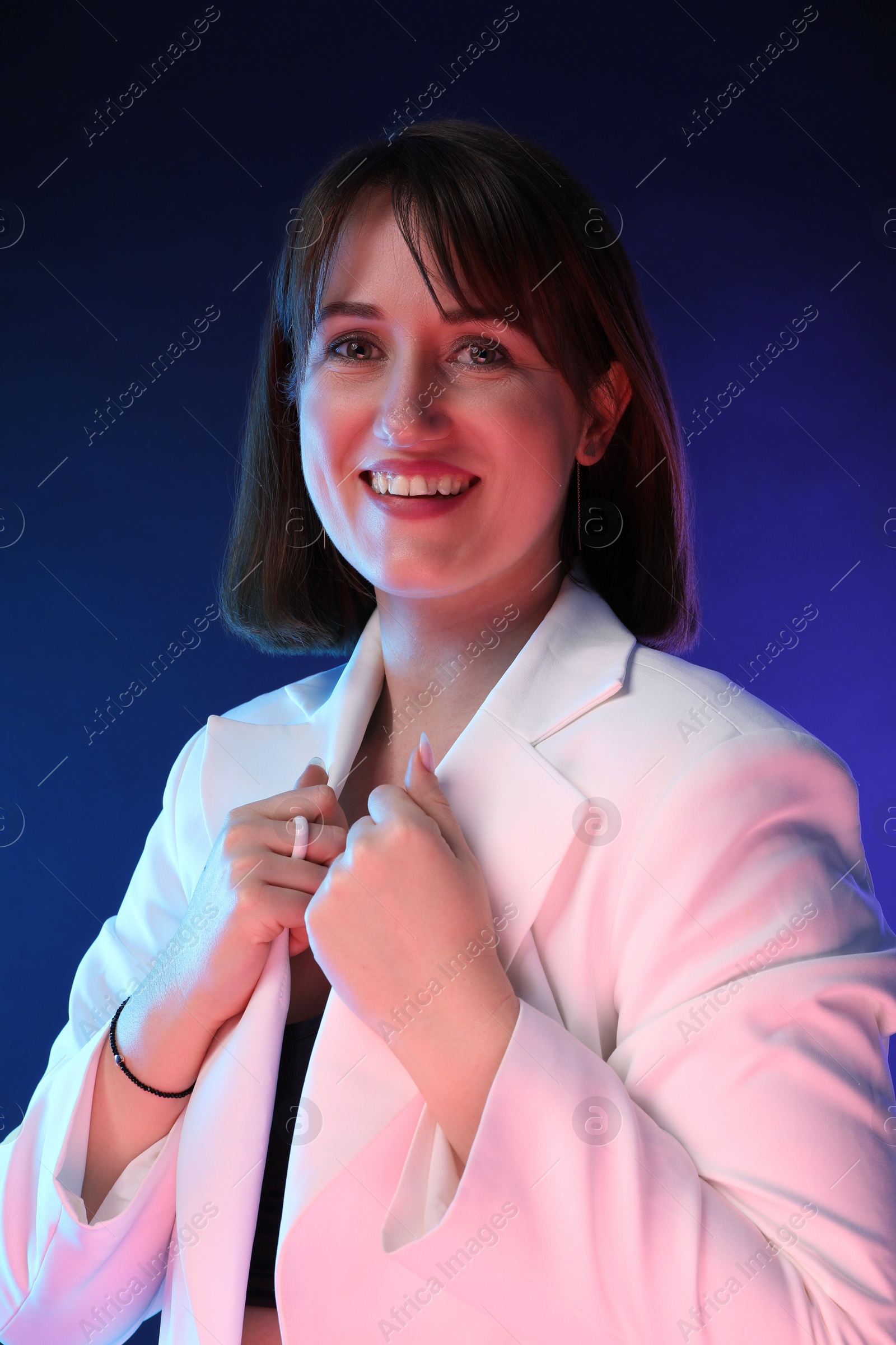 Photo of Portrait of happy woman on dark background