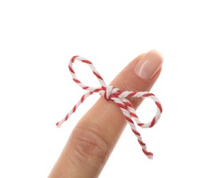 Photo of Woman showing index finger with tied bow as reminder on white background, closeup