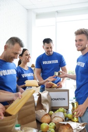 Photo of Team of volunteers collecting food donations indoors