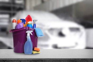 Image of Bucket with cleaning supplies on grey stone surface at car wash. Space for text