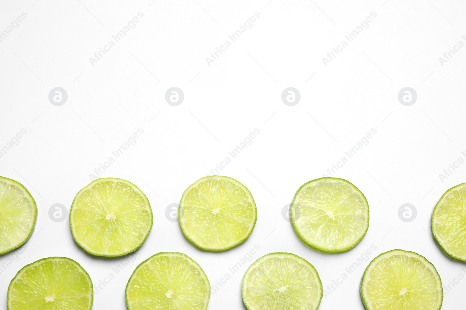 Photo of Juicy fresh lime slices on white background, top view