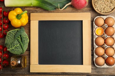 Photo of Blank chalkboard and different fresh products on wooden table, flat lay with space for text. Cooking Classes