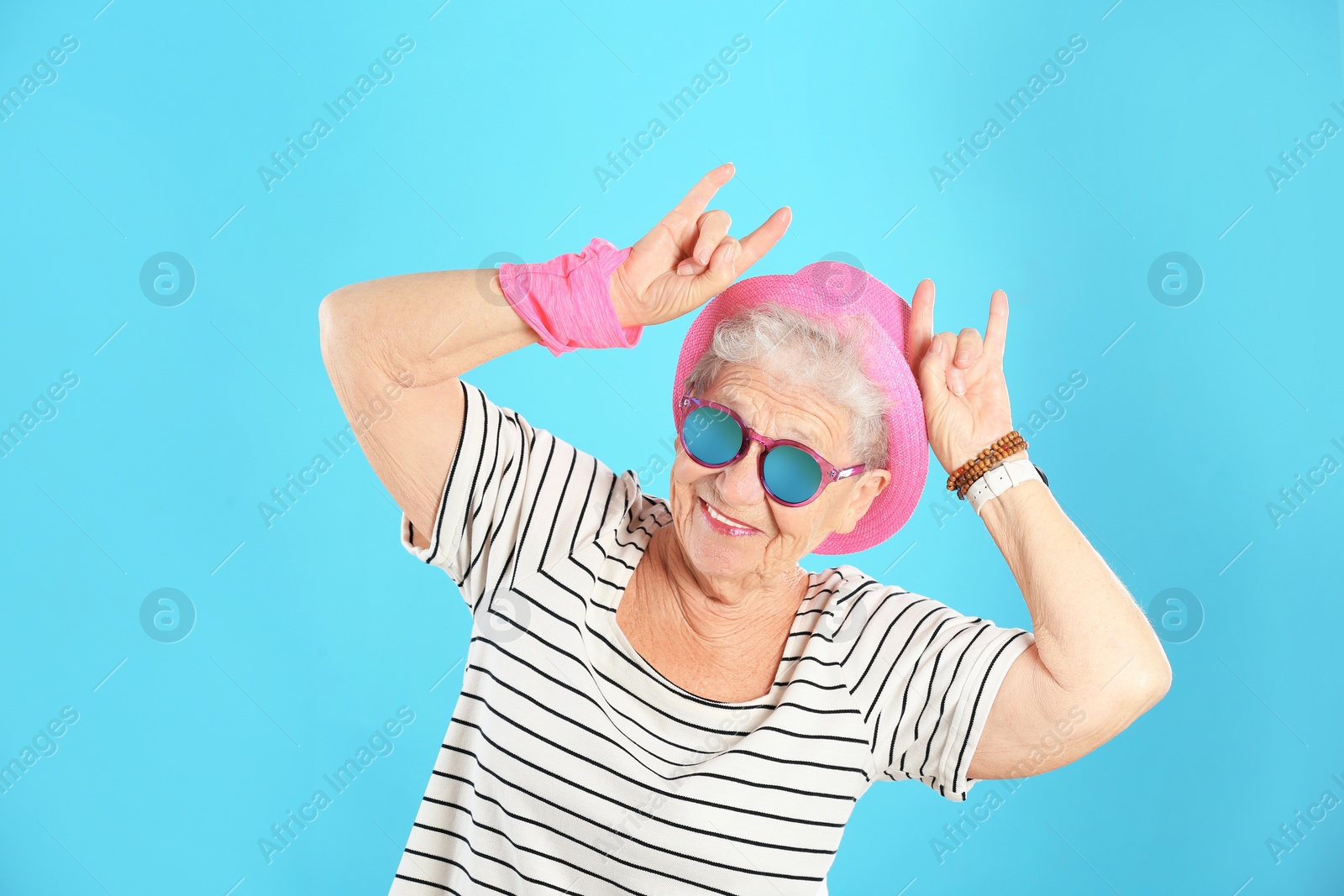 Photo of Portrait of cool grandmother on color background