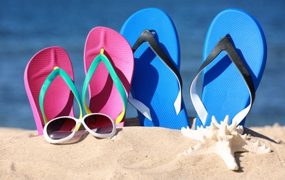 Photo of Composition with beach accessories on sand near sea in summer