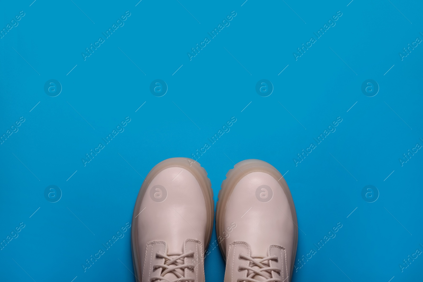 Photo of Pair of stylish leather shoes on light blue background, flat lay. Space for text