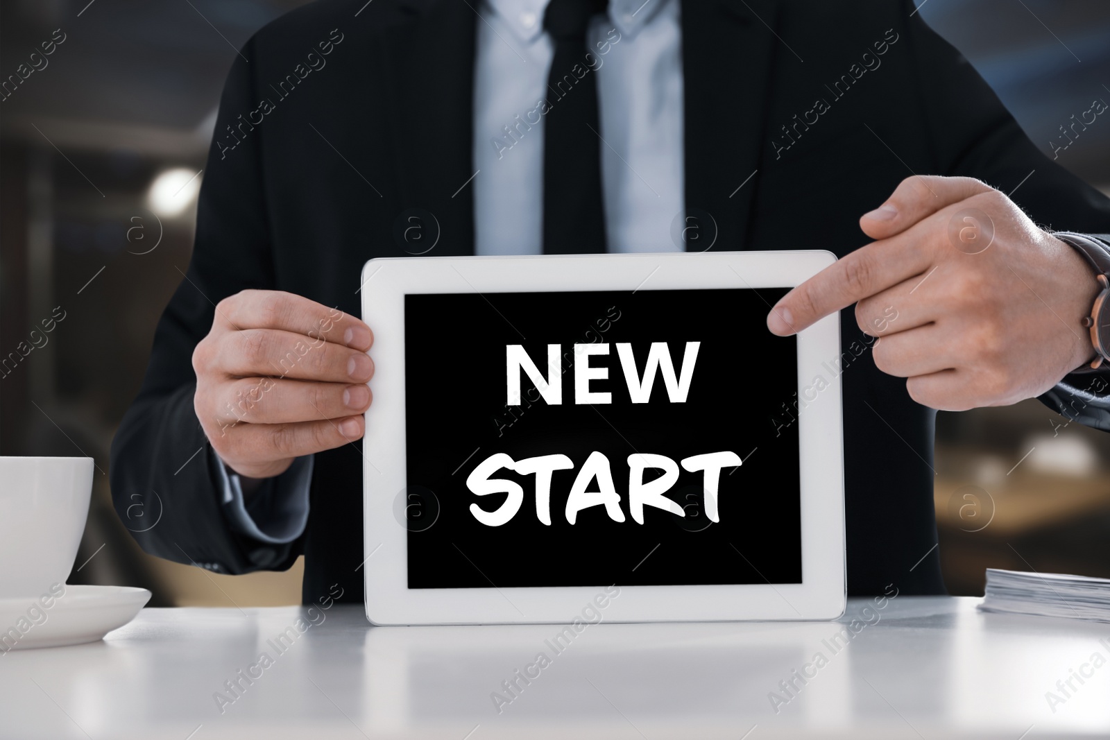 Image of Fresh opportunities. Business owner holding tablet with text New Start at table, closeup