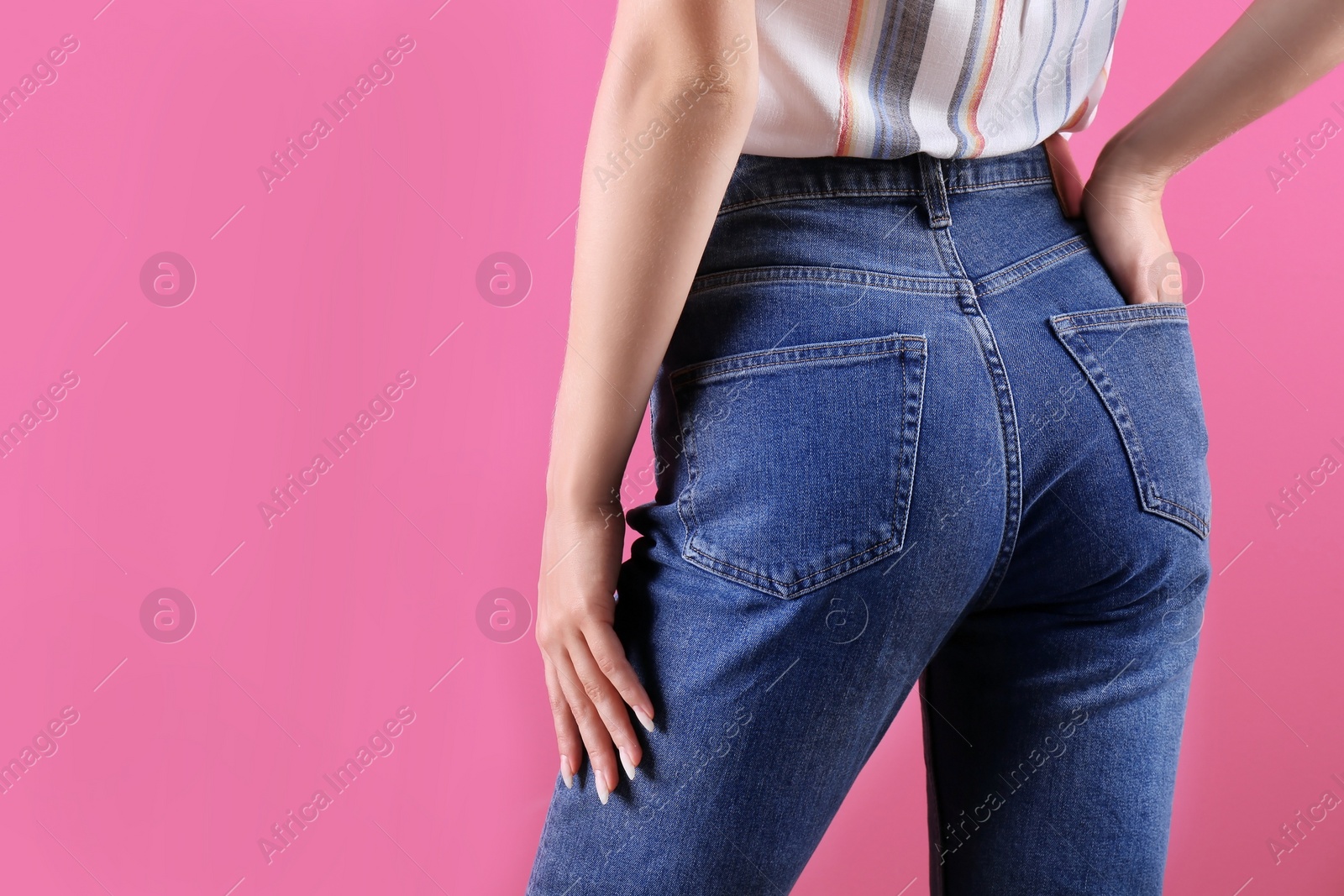 Photo of Woman in stylish blue jeans on color background