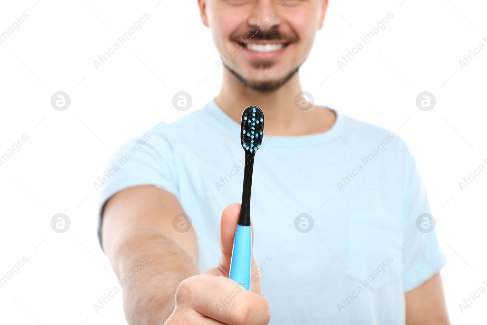 Photo of Young man with toothbrush on white background, closeup. Teeth care