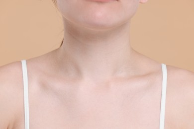 Closeup view of woman with healthy skin on beige background