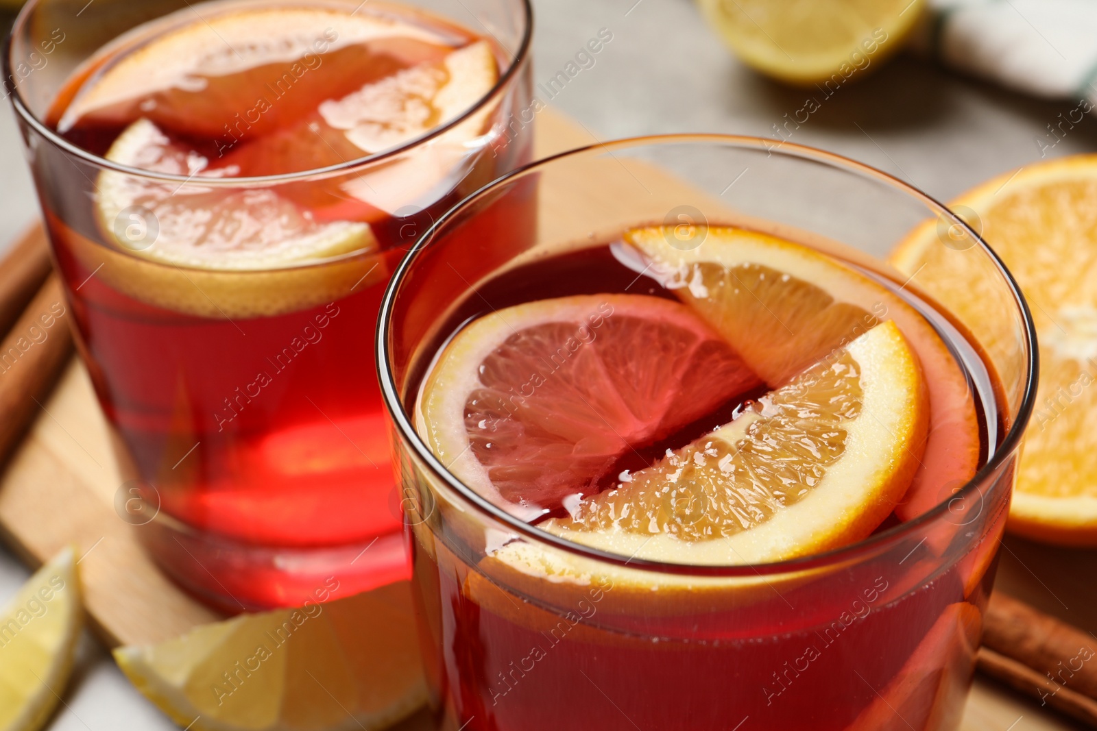 Photo of Glasses with aromatic punch drink on table, closeup view