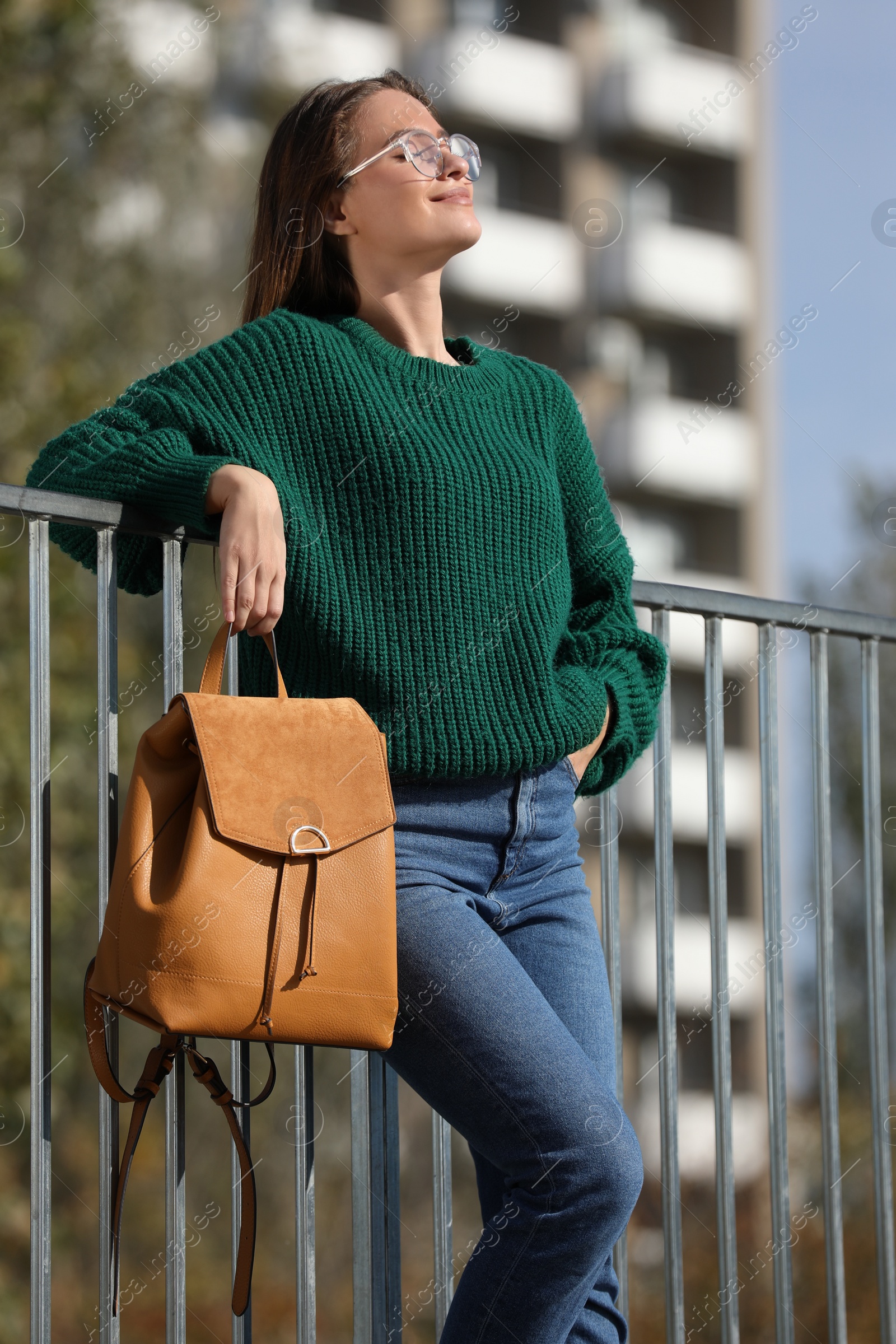 Photo of Young woman with stylish backpack on autumn day