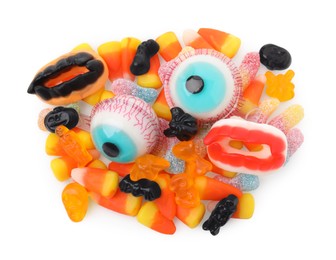 Photo of Delicious colorful candies on white background, top view. Halloween sweets