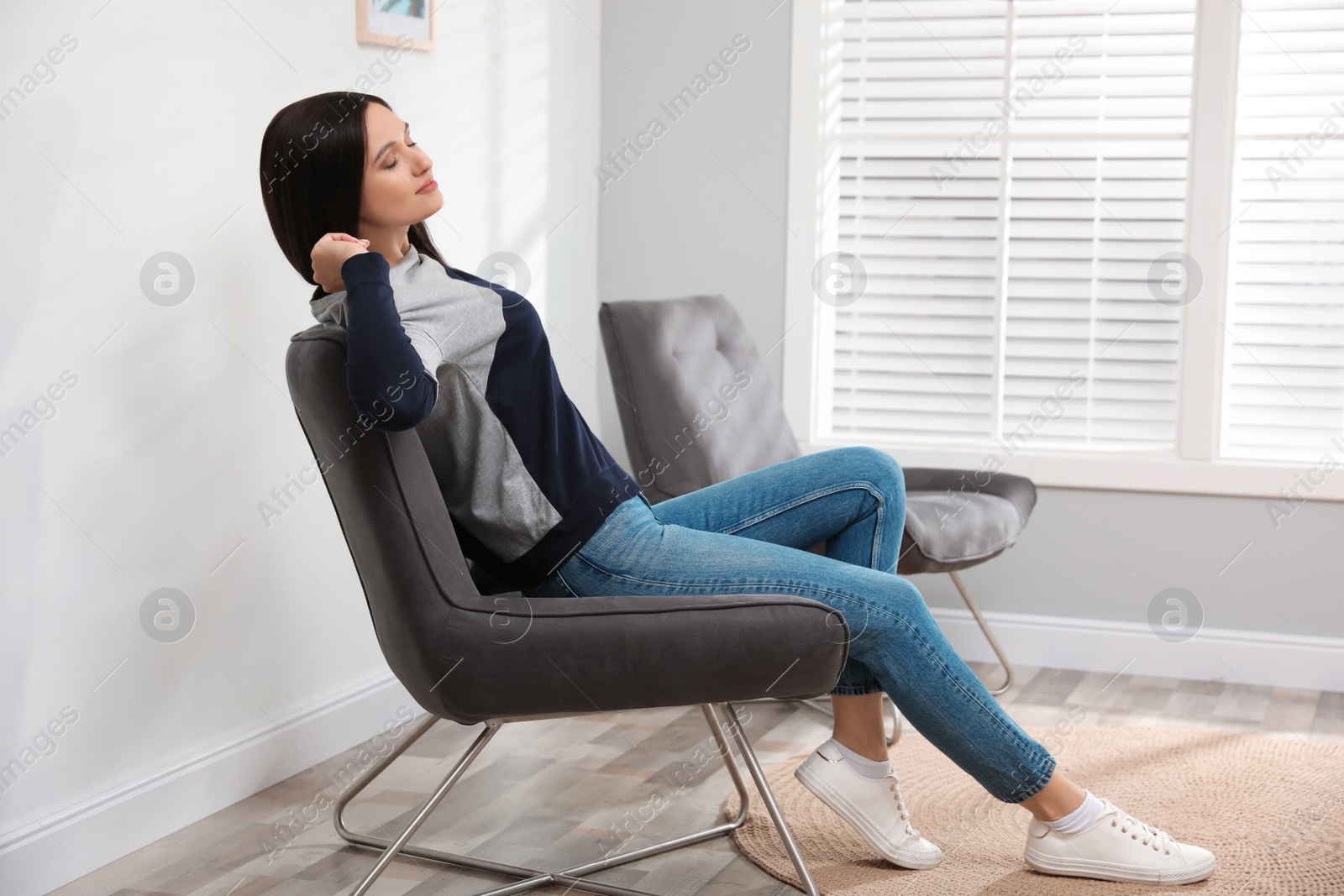 Photo of Young woman relaxing at home. Peaceful rest