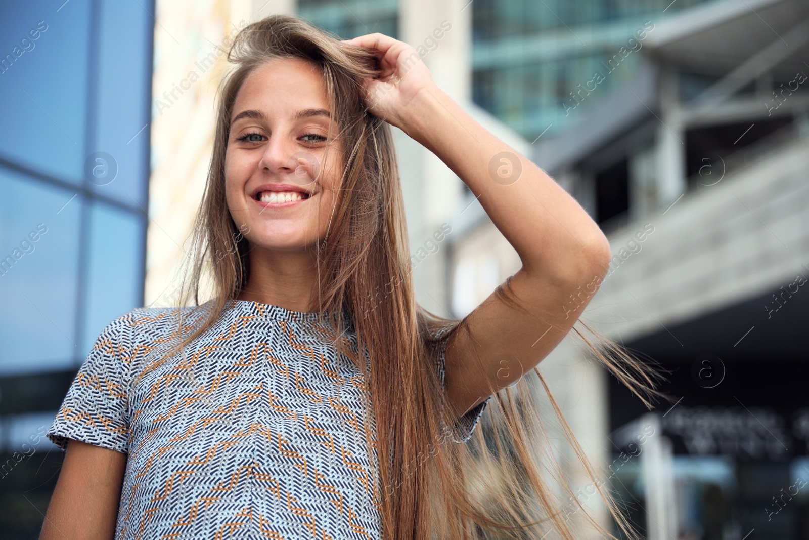 Photo of Portrait of beautiful young woman near building outdoors