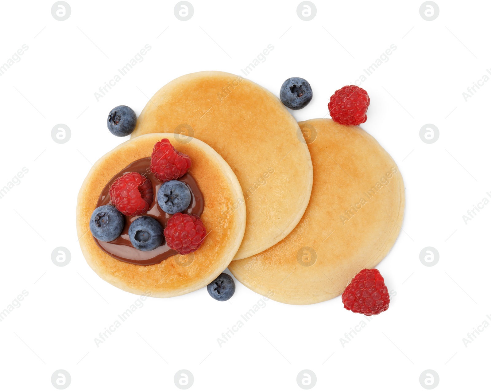 Photo of Tasty pancakes with chocolate spread and berries isolated on white, top view