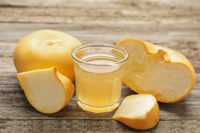 Glass of freshly made turnip juice on wooden table