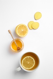 Composition with lemon tea, honey and ginger on white background, top view