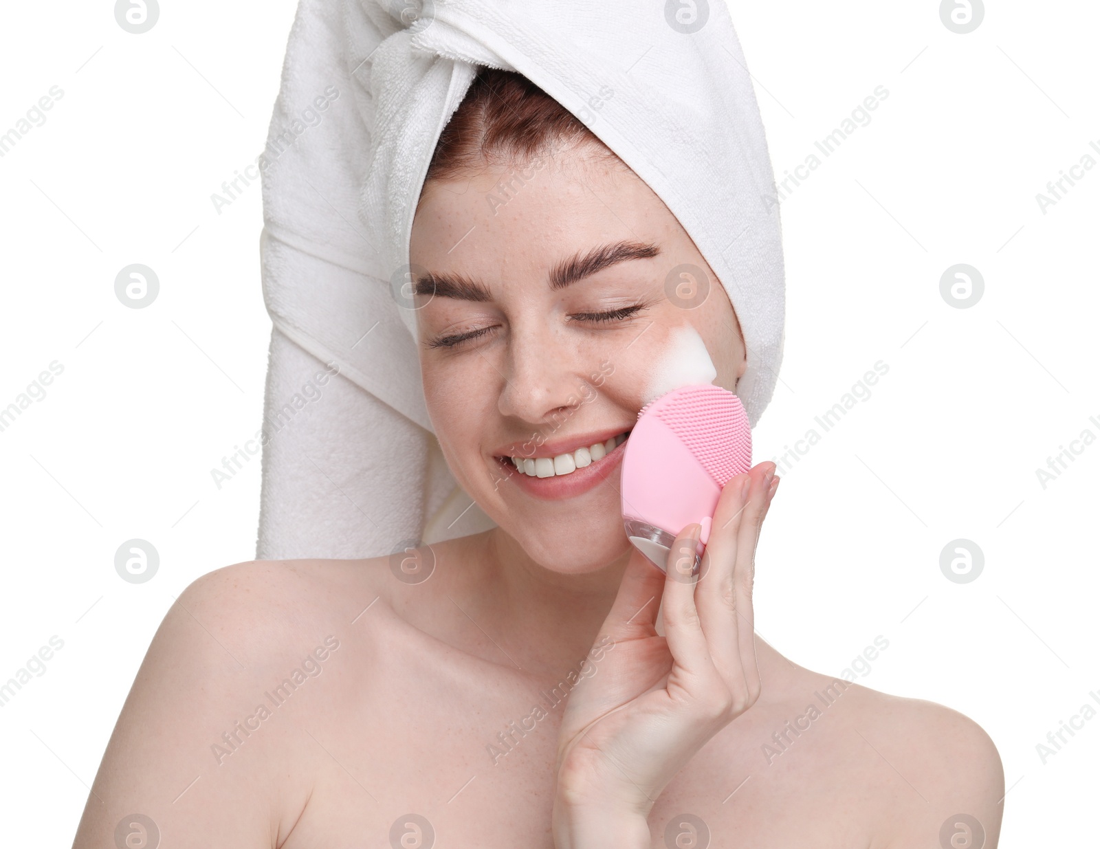 Photo of Young woman washing face with brush and cleansing foam on white background