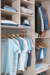 Stylish clothes and home stuff in large wardrobe closet