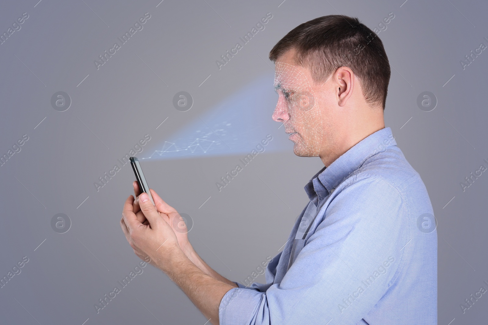 Image of Man unlocking smartphone with facial scanner on grey background. Biometric verification