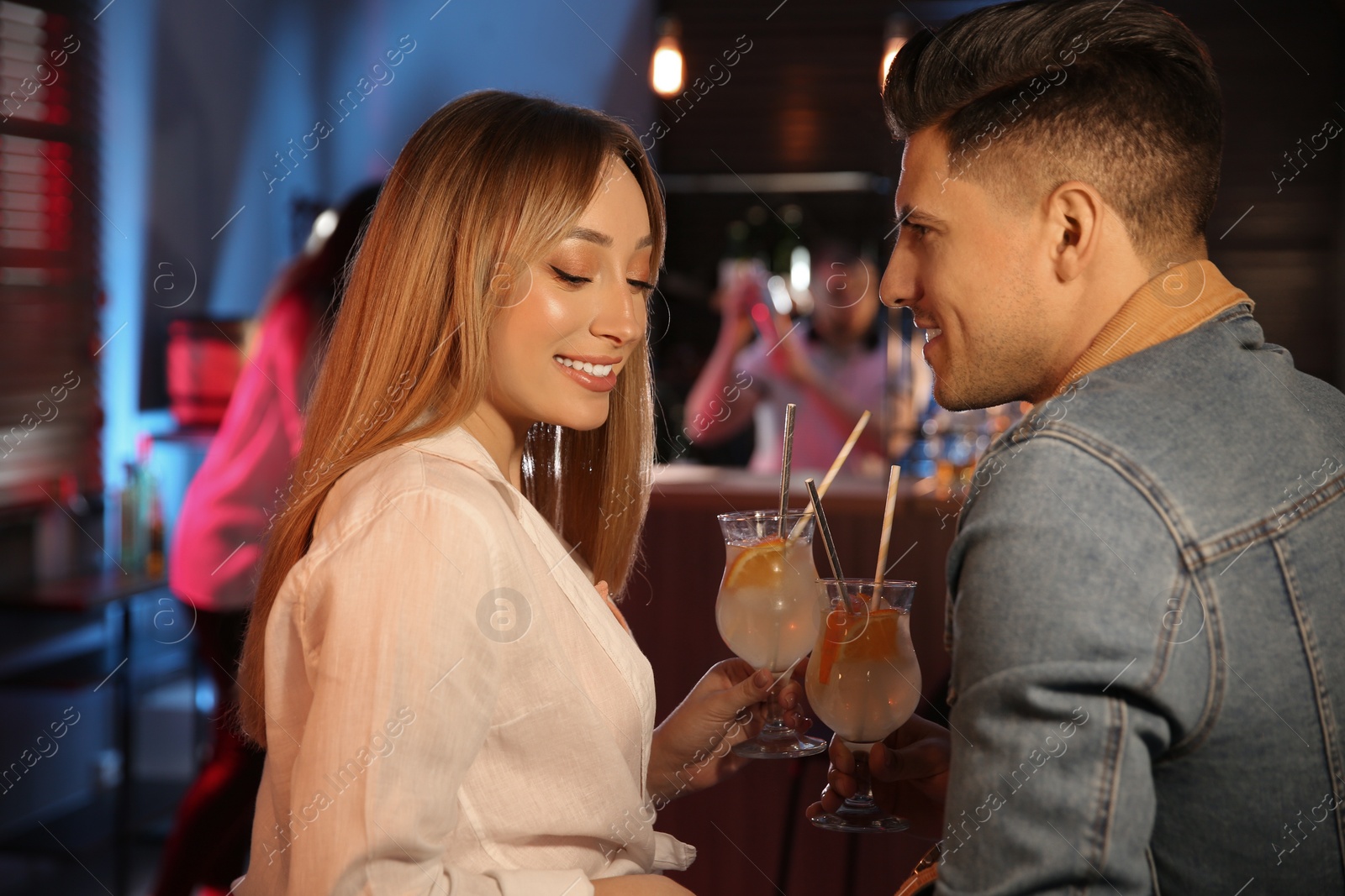 Photo of Man and woman flirting with each other in bar