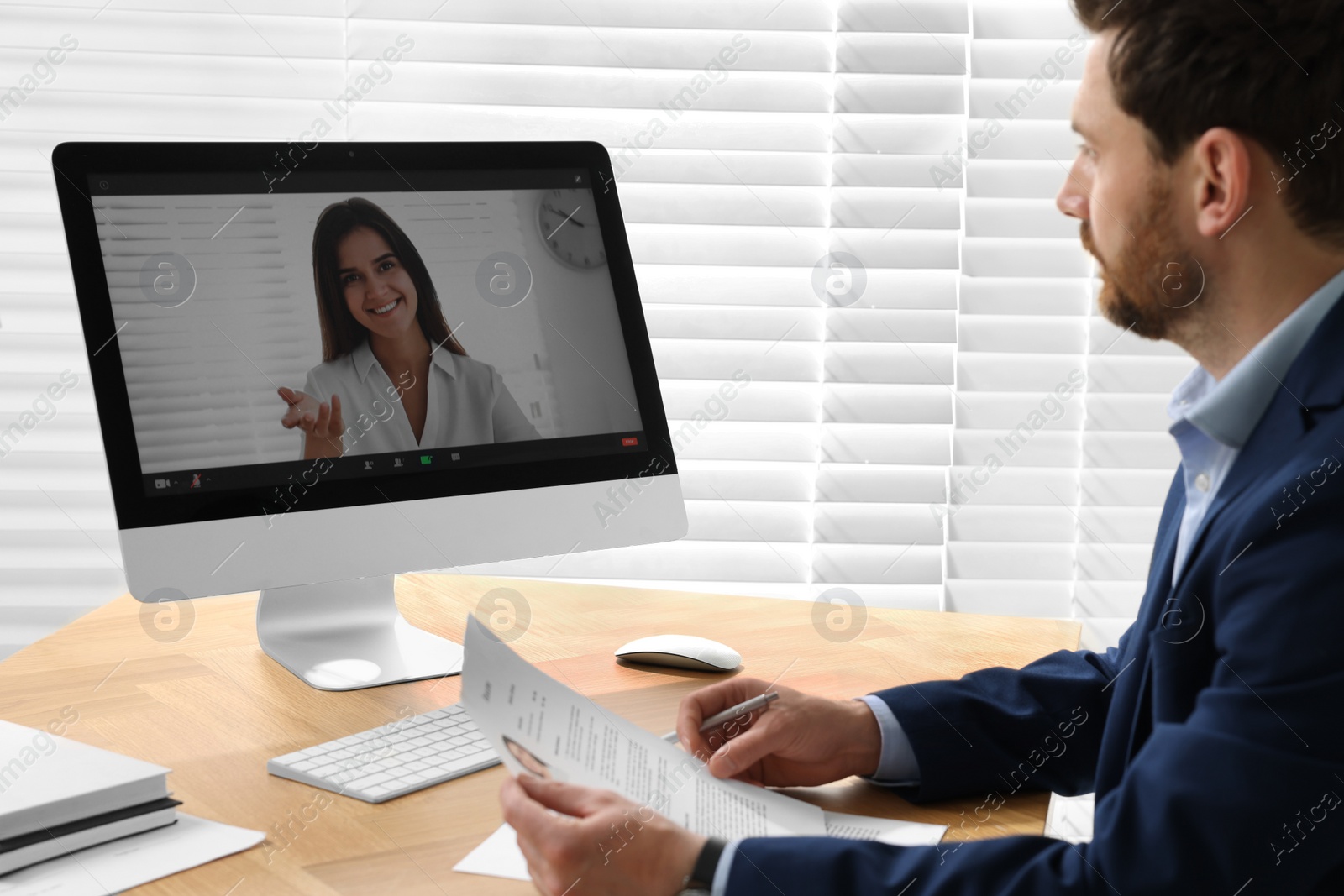 Photo of Human resources manager conducting online job interview via video chat on computer