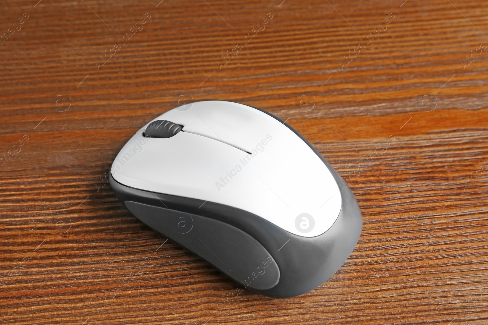 Photo of Wireless computer mouse on wooden background