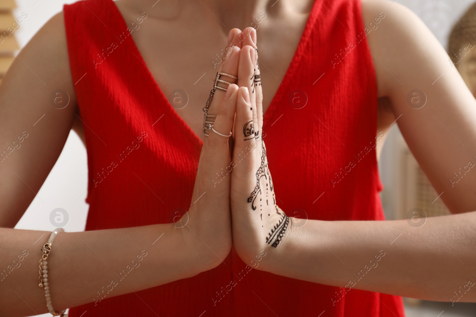 Photo of Woman with henna tattoo on hand, closeup. Traditional mehndi ornament