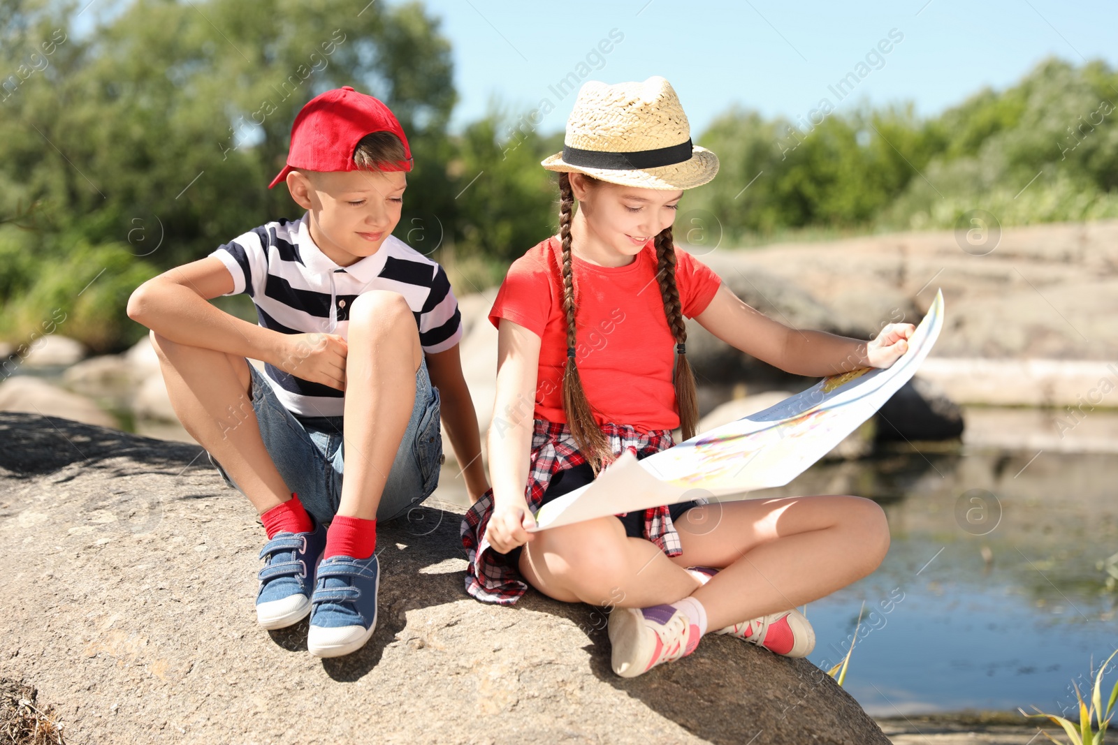 Photo of Little children with map outdoors. Summer camp