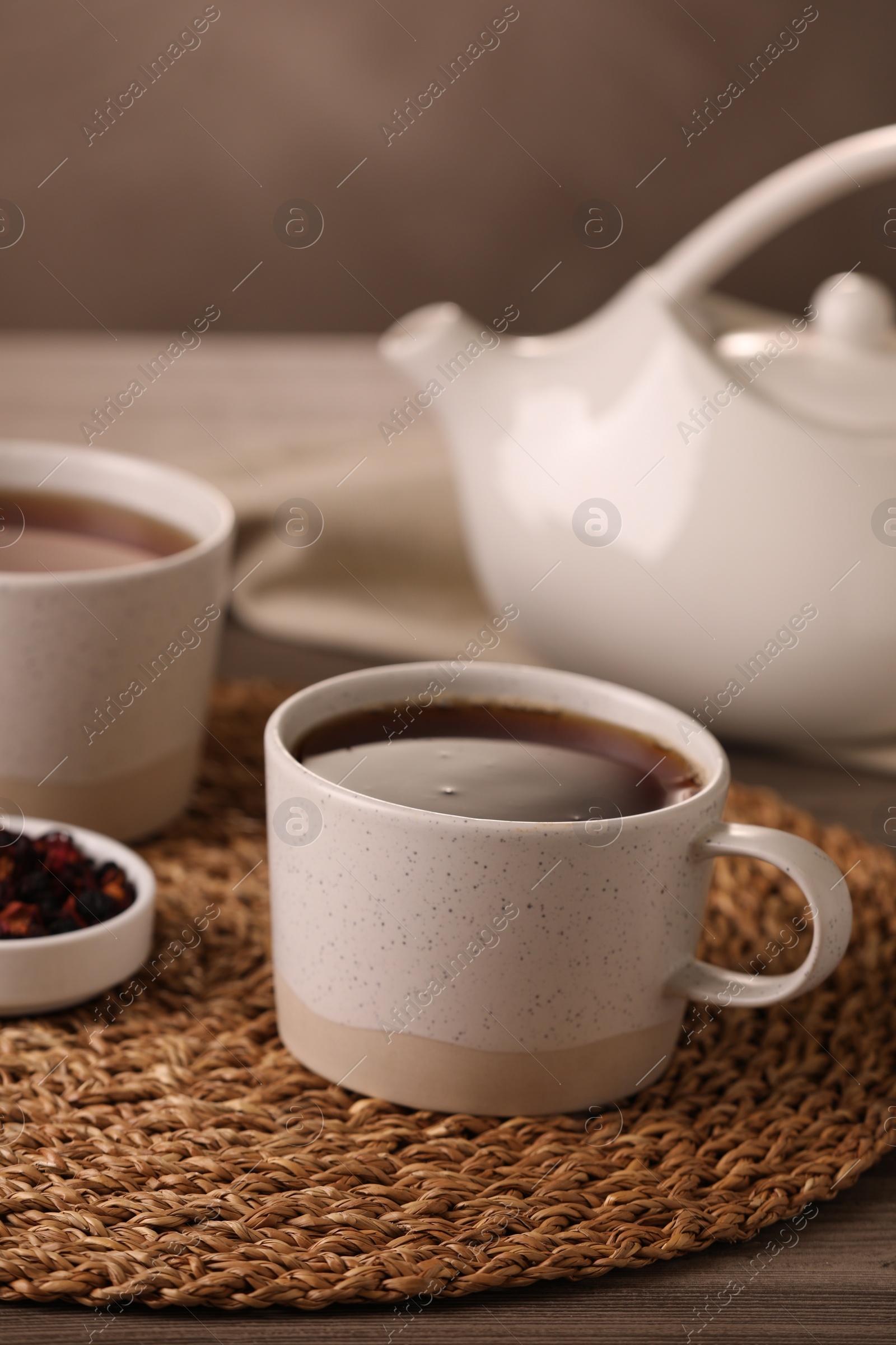 Photo of Aromatic tea and dry flower petals on wooden table