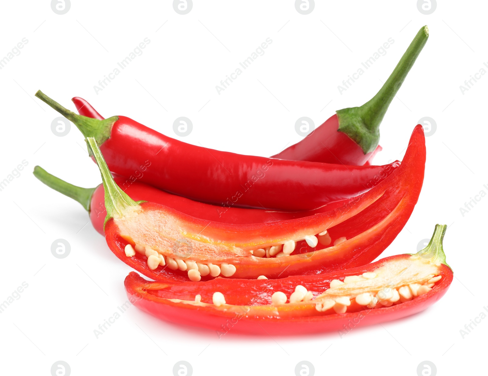 Photo of Cut and whole red hot chili peppers on white background