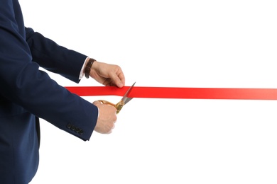 Photo of Man in office suit cutting red ribbon isolated on white, closeup