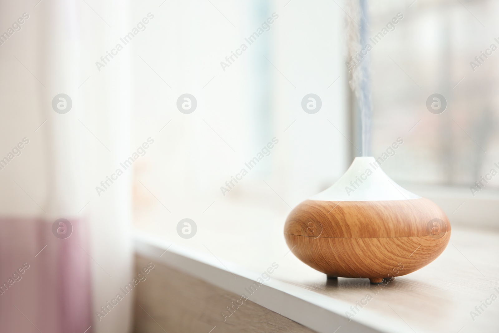 Photo of Aroma oil diffuser on window sill