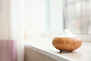 Photo of Aroma oil diffuser on window sill