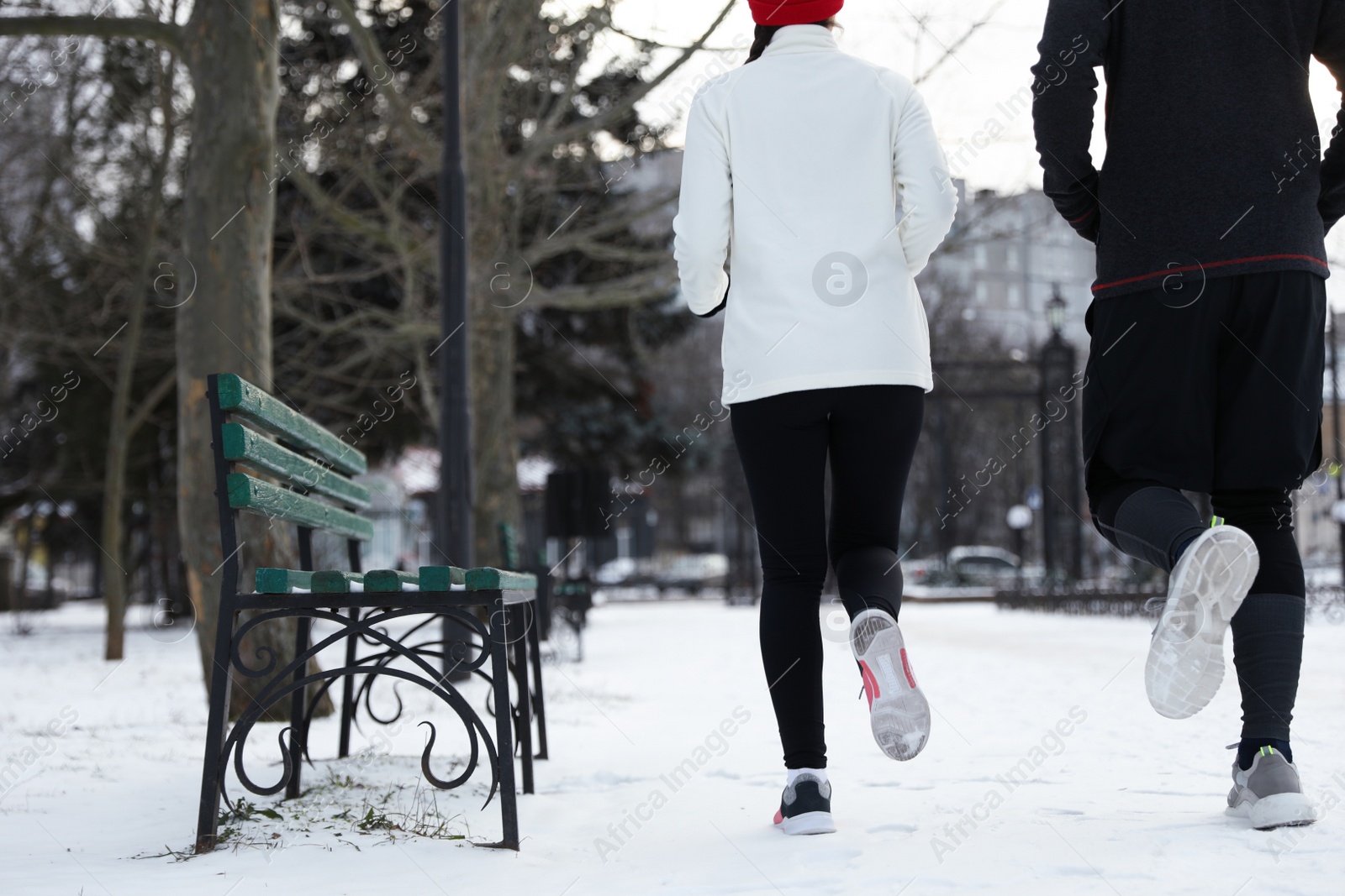 Photo of People running in winter park, closeup. Outdoors sports exercises