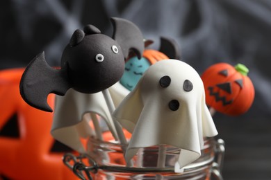 Photo of Different Halloween themed cake pops on dark background, closeup