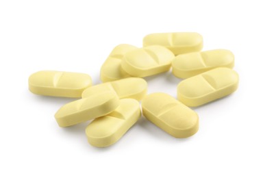 Photo of Many yellow pills isolated on white. Medicinal treatment
