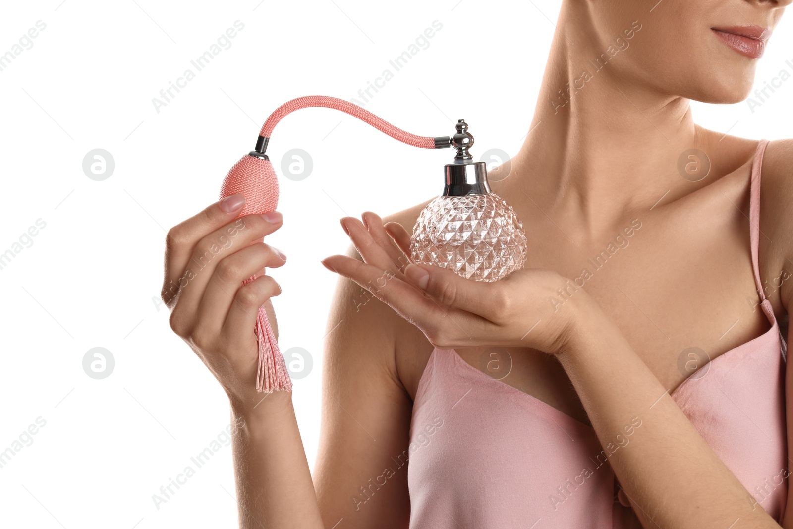 Photo of Young woman applying perfume on white background, closeup