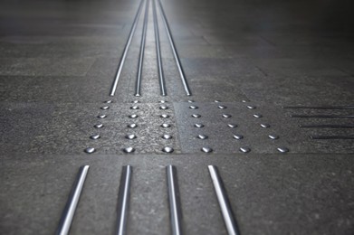 Photo of Floor tiles with tactile ground surface indicators, closeup view