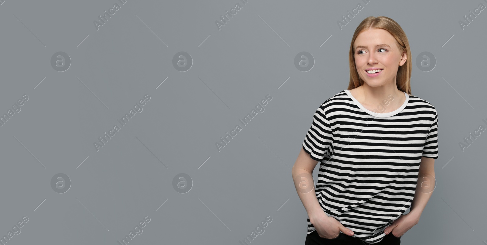 Image of Portrait of beautiful young woman on grey background. Banner design with space for text