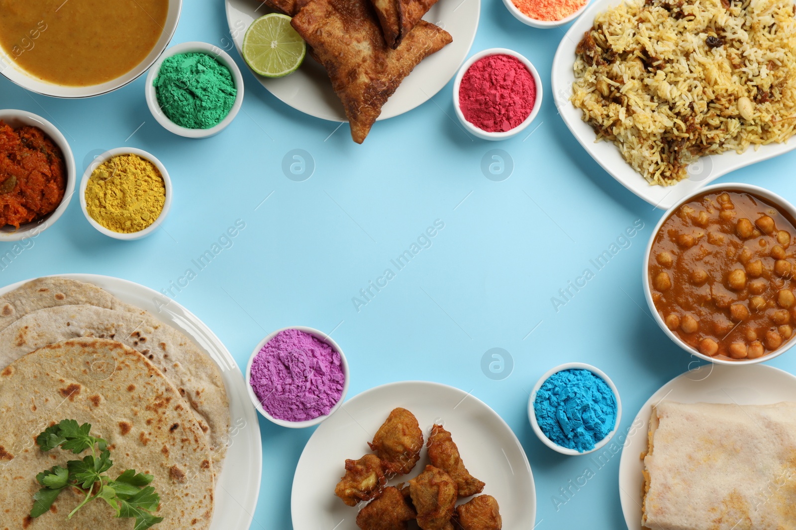 Photo of Flat lay of traditional Indian food and color powder dyes on turquoise background, space for text. Holi festival