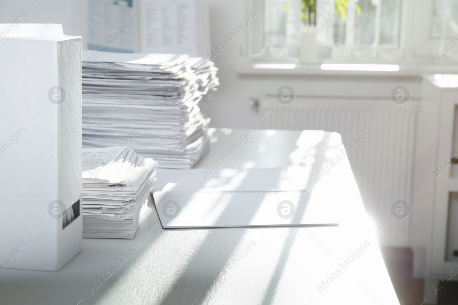 Photo of Stacks of documents on table in office