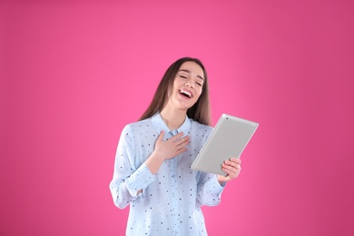 Woman using tablet for video chat on color background