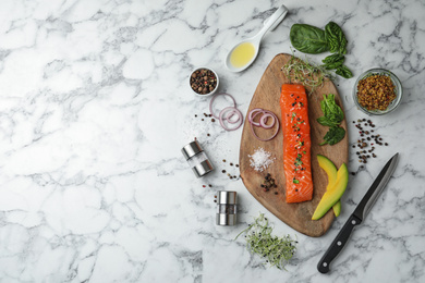 Photo of Delicious salmon with spinach and avocado served on white marble table, flat lay. Space for text