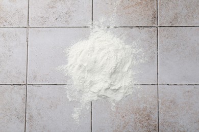 Photo of Pile of baking powder on light tiled table, top view