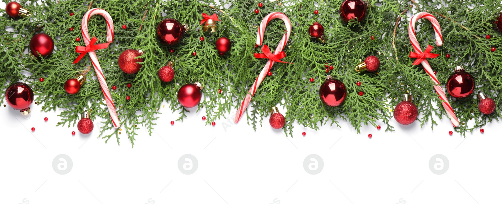 Photo of Thuja branches with Christmas decorations on white background, flat lay