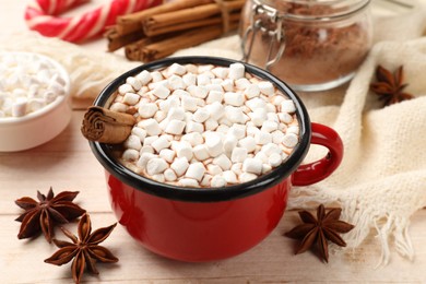 Tasty hot chocolate with marshmallows on white wooden table, closeup