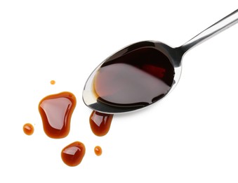 Tasty soy sauce in spoon isolated on white, top view